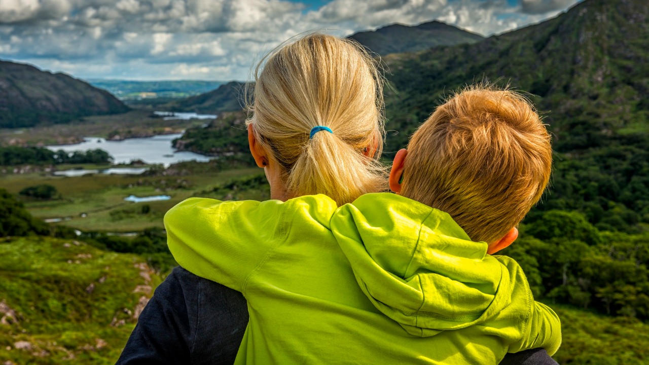 woman and boy looking over wide irish landscape